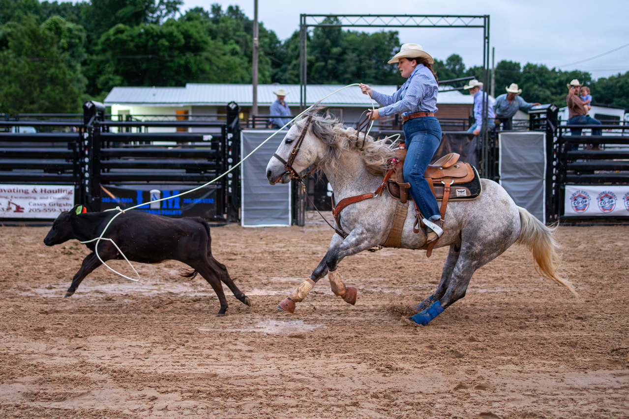 Cowgirl competing in breakaway roping at a Western Sports Extreme event