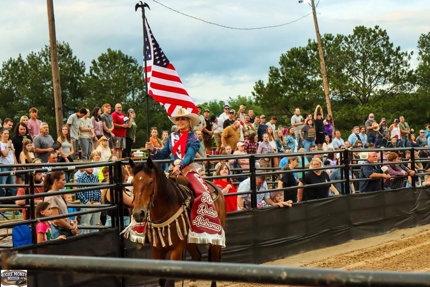 American flag carried on horseback past the WSE crowd
